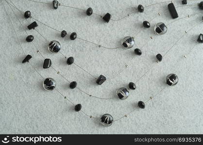 Black beads displayed on wire isolated on a white background