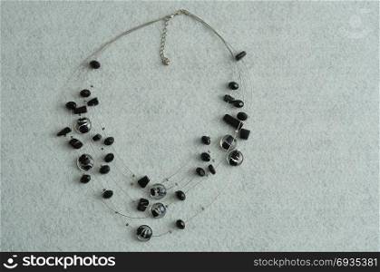 Black beads displayed on wire isolated on a white background