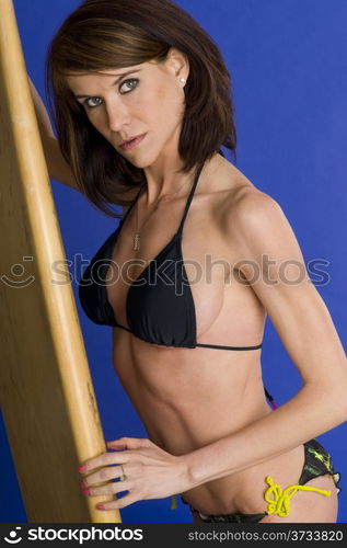 Black Beauty Woman Swimsuit Bikini Holds Well Worn Surfboard