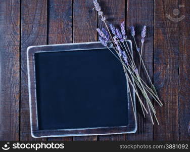 black board and fresh lavender on the wooden table