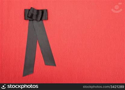 Black bow on red background