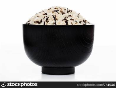 Black bowl of raw organic basmati long grain and wild rice on white background.