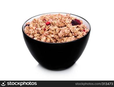 Black bowl with natural organic granola cereal with summer fruits on white