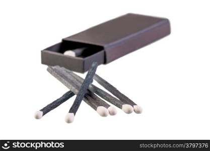 black box of matches lying near on a white background