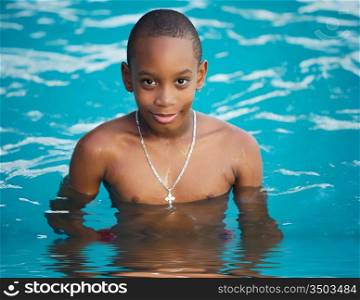 Black boy in the swimming pool in summer
