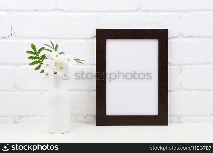 Black brown frame mockup with flowering white Tobacco plant. Empty frame mock up with Nicotiana flowers for presentation design. Template framing for modern art.