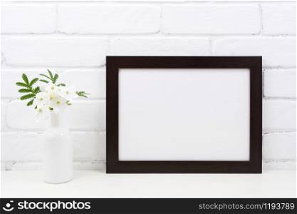 Black brown landscape frame mockup with flowering white Tobacco plant. Empty frame mock up with Nicotiana flowers for presentation design. Template framing for modern art.