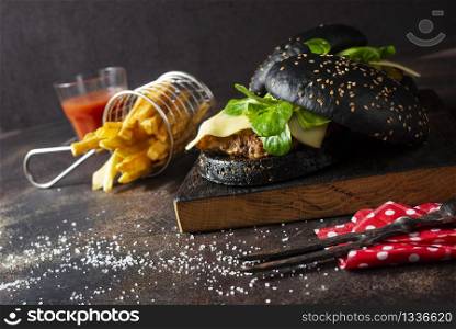 black burger with potato free on wooden board