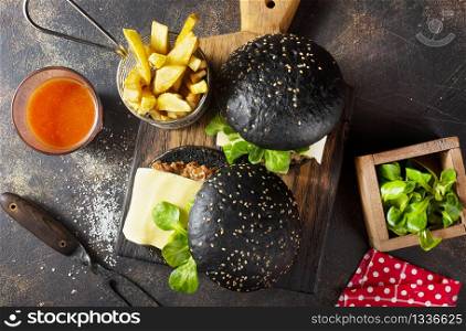 black burger with potato free on wooden board