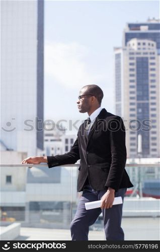 black businessman portrait on skyscrapers background