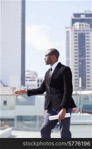 black businessman portrait on skyscrapers background