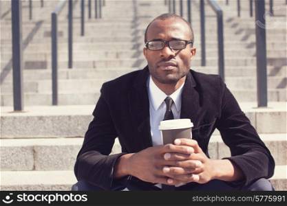 black businessman sitting with coffee during a lunch
