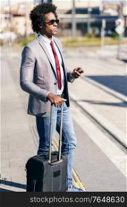 Black Businessman waiting for the next train. Man with afro hair commuting.. Black Businessman waiting for the next train