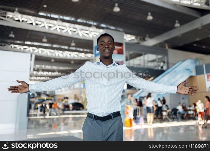 Black businessman welcomes the guests car showroom. Successful business person on motor show, black man in formal wear. Black businessman welcomes guests, car showroom