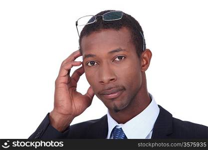 Black businessman with glasses on his head