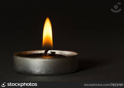 Black candle with black background