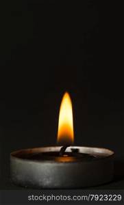 Black candle with black background