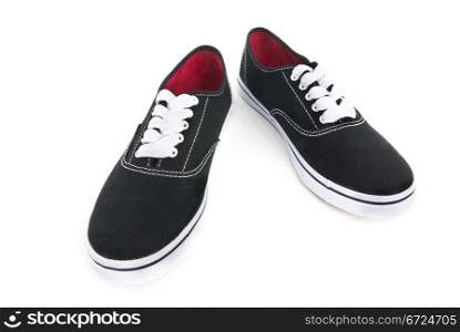 Black canvas shoes with white shoelaces on white background