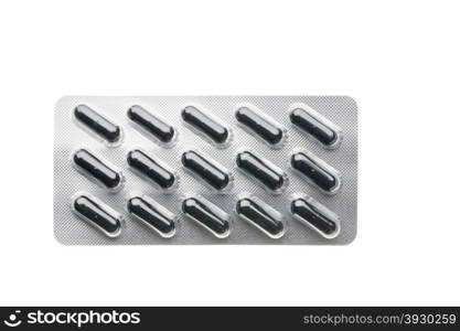 Black capsules in blister pack closeup isolated. Black capsules in blister pack closeup isolated on white background