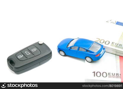 black car keys, blue car and euro notes on white