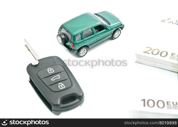 black car keys, euro notes and green car on white