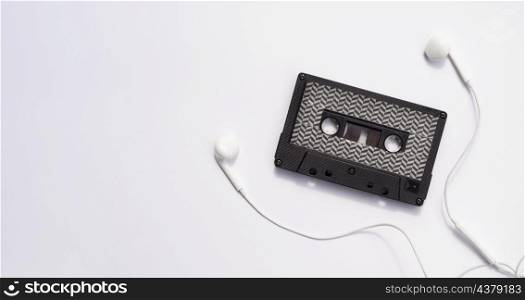black cassette tape with earphones copy space