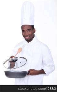black chef holding pan