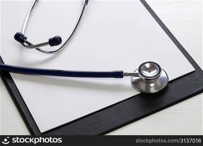 Black clipboard with stethoscope. Medicine concept.