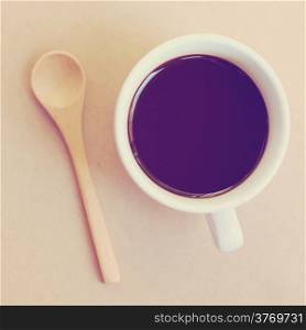 Black coffee and spoon with retro filter effect
