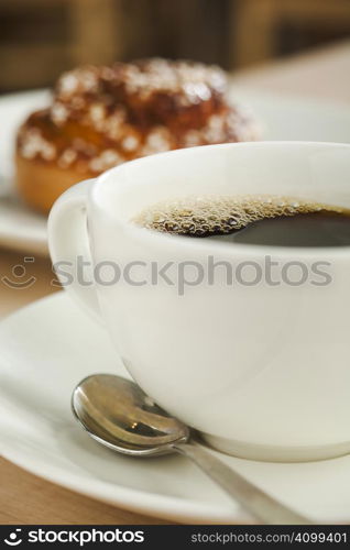 Black coffee cup with dessert bun
