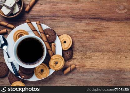 black coffee in white cup with cookie and dessert