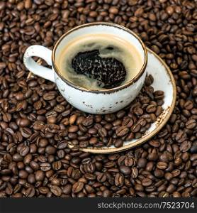 Black coffee on coffee beans background