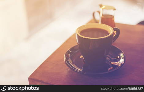 black coffee on the table in cafe, vintage filter image