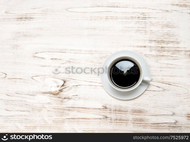 Black coffee on wooden table. Vintage style still life with copy space