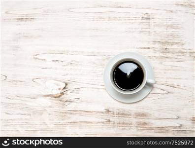 Black coffee on wooden table. Vintage style still life with copy space