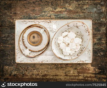 Black coffee with meringue cookies. Retro style still life. Vintage toned picture vigtte