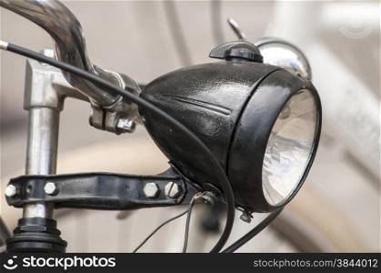 Black colored retro vintage bicycle headlight closeup