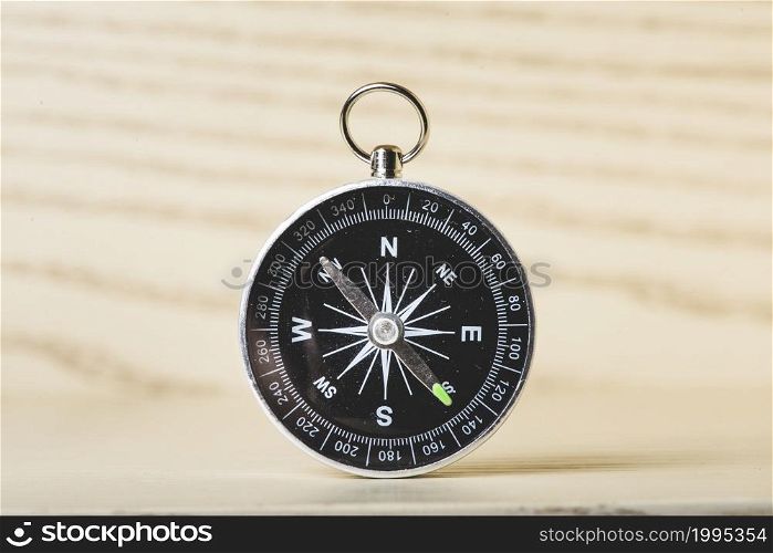 black compass wooden surface
