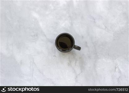 Black cup of coffee on marble table background. Top view Copy space Minimal style.. Black cup of coffee on marble table background. Top view Copy space Minimal style