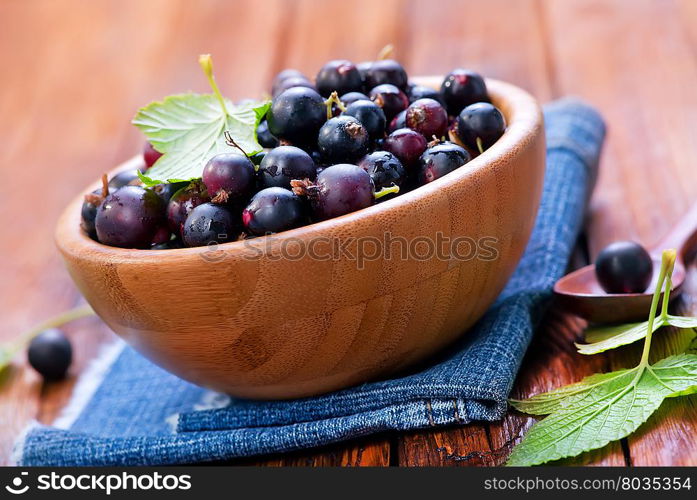 black currant in bowl and on a table