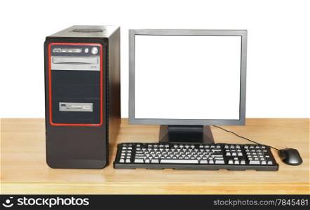black desktop computer, display with cut out screen, keyboard, mouse on wooden table isolated on white background