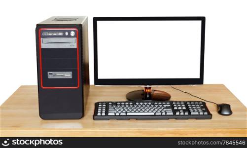 black desktop computer, widescreen display with cutout screen, keyboard, mouse on wooden table isolated on white background