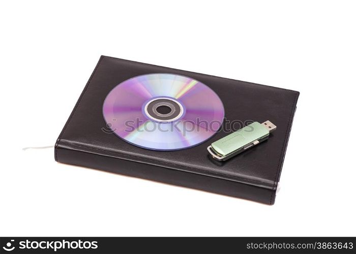 Black diary, flash drive and cd on a white background
