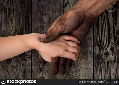 black dirty man hands holding kid clean hand concept
