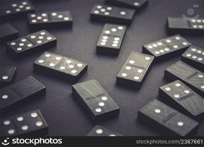 Black dominoes on a dark table background. Black dominoes on dark table background
