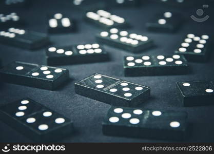 Black dominoes on a dark table background. Black dominoes on dark table background