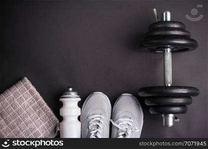 black dumbbell training with accessories on dark background