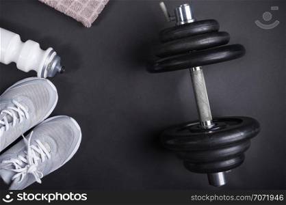 black dumbbell training with accessories on dark background