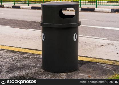 Black dustbin or trashcan beside the road, Container beside country street