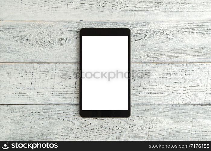 black electronic tablet on vintage shabby white wooden background. the view from the top. flat lay